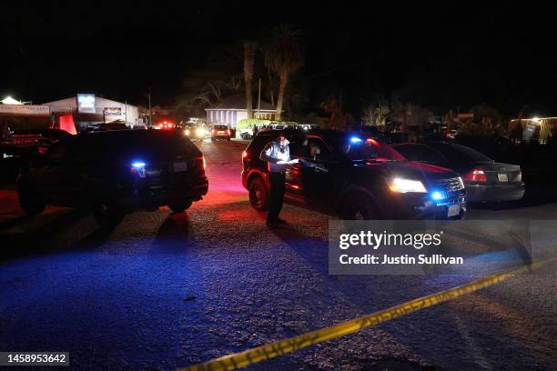 San Mateo County sheriff does paperwork at the scene of a shooting on January 23, 2023 in Half Moon Bay, California. Seven people were killed at two...