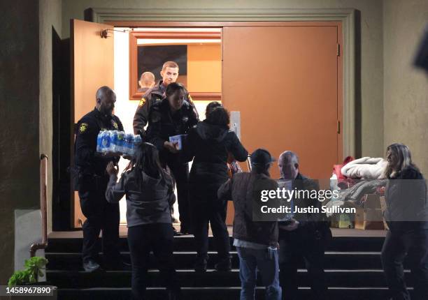 San Mateo County sheriff deputies collect food and drink donations outside of a family reunification center following a mass shooting on January 23,...