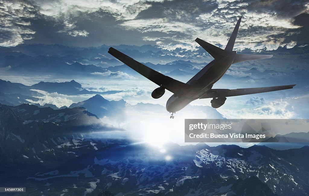 Airplane flying  over a troubled  mountain landsca