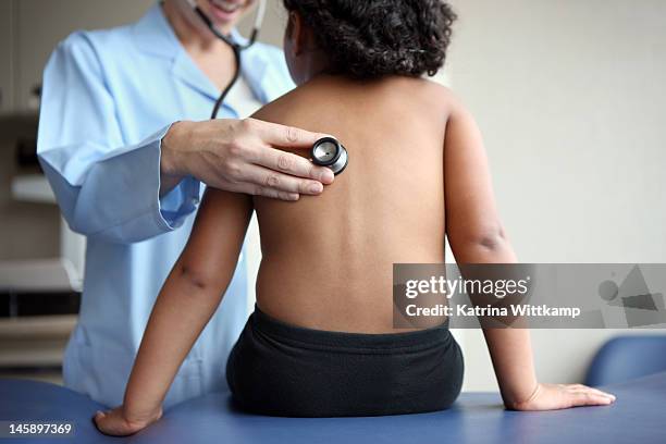 doctor listens to girl's breathing. - stethoscope child stock pictures, royalty-free photos & images