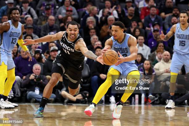 Trey Lyles of the Sacramento Kings goes for a loose ball against Desmond Bane of the Memphis Grizzlies in the second half at Golden 1 Center on...