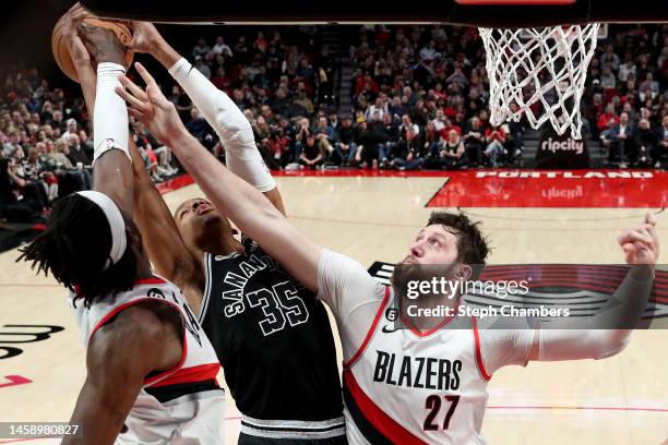 Jerami Grant and Jusuf Nurkic of the Portland Trail Blazers block the shot of Romeo Langford of the San Antonio Spurs during the second quarter at...