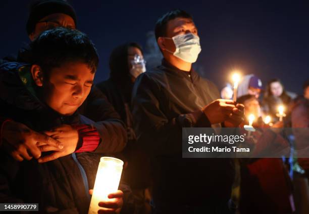 People gather at a candlelight vigil for victims of a deadly mass shooting at a ballroom dance studio on January 23, 2023 in Monterey Park,...