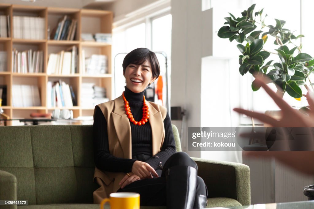 Young businesswoman chatting with colleagues in a creative office.