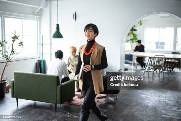 confident businesswoman walking in creative office - work japan stock pictures, royalty-free photos & images
