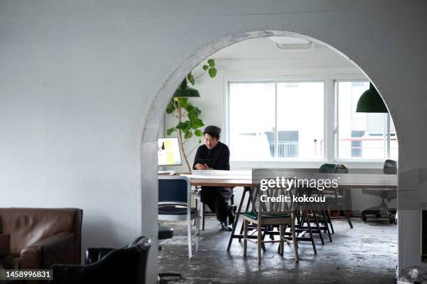 mature man working in a creative office - 33 arches stock pictures, royalty-free photos & images