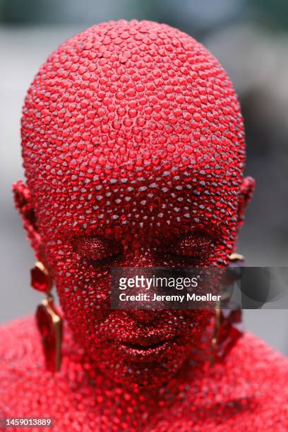 Doja Cat is seen wearing a full red glittery Look ,long dress and earrings outside Schiaparelli show, during the Paris Fashion Week - Haute Couture...