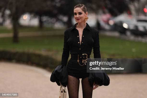 Chiara Ferragni seen wearing a black blazer with and golden Schiaparelli statement earrings and Schiaparelli hairdetails, black tights with dots and...