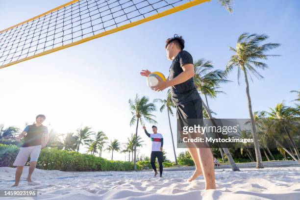 southeast asians playing beach volley - beach volley imagens e fotografias de stock