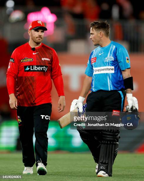 Cameron Boyce of the Strikers is seen talking to Aaron Finch of the Renegades afrer being dismissed during the Men's Big Bash League match between...