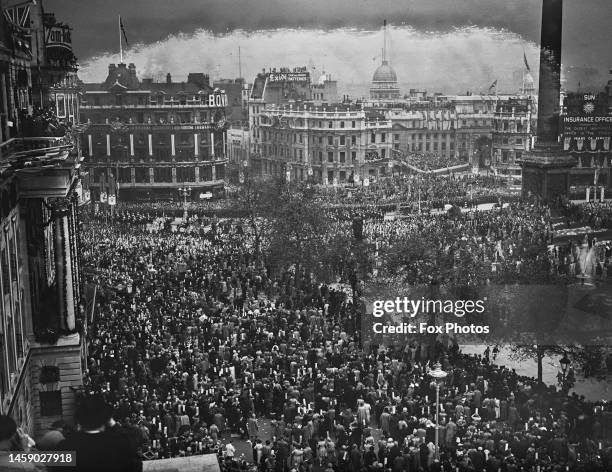 The crowd waiting to see the Gold State Coach, in which George VI and Queen Elizabeth are riding, in Trafalgar Square, en route to the coronation...