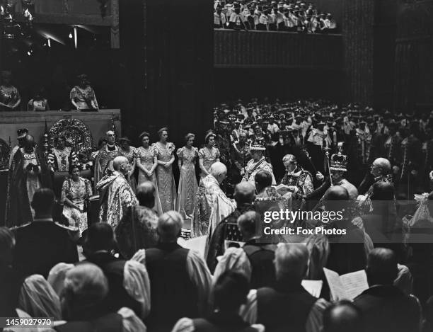 George VI seated wearing the Imperial State Crown after the coronation ceremony, conducted by British clergyman Cosmo Gordon Lang , Archbishop of...