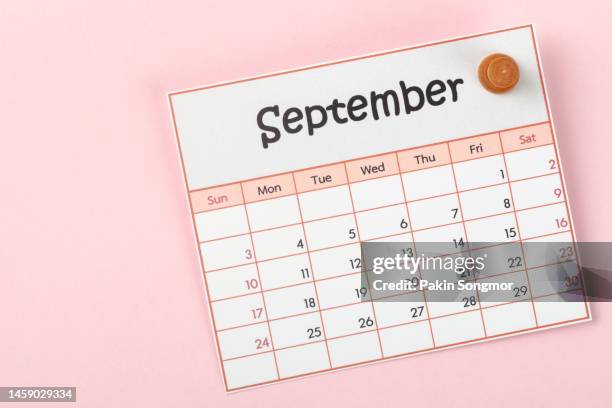calendar desk 2023: september is the month for the organizer to plan and deadline with a push pin on a paper background. - setembro imagens e fotografias de stock