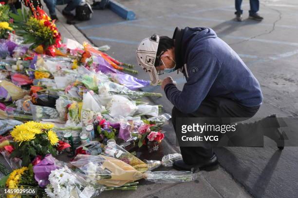 Mourners attend a candlelight vigil for victims of a mass shooting in front of the City Hall on January 23, 2023 in Monterey Park, California. At...