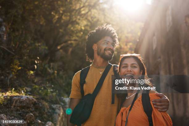 young couple looking away on sunny day - indian ethnicity travel stock pictures, royalty-free photos & images