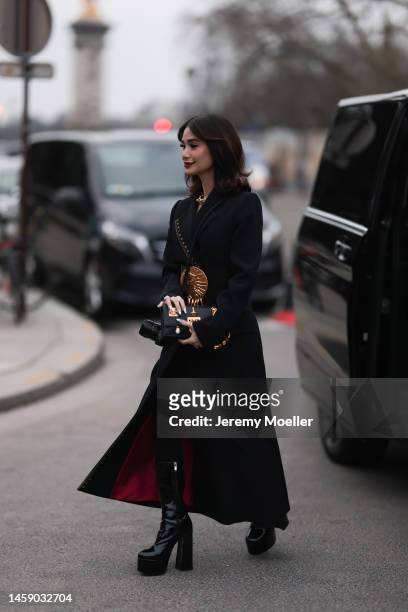 Heart Evangelista seen wearing diamonds earrings, a gold large chain necklace from Tiffany, a black long coat from Schiaparelli, a black shiny...