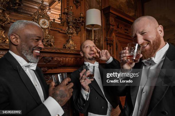 three handsome 1920s style gentlemen in a luxury stately home - flapper stock pictures, royalty-free photos & images