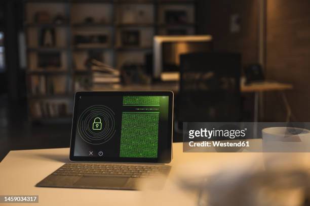 tablet pc with security system and data on screen in office - computer code stock pictures, royalty-free photos & images