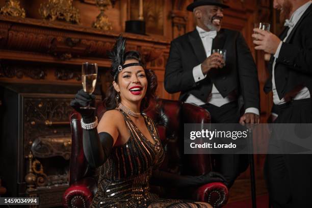 three handsome 1920s style gentlemen in a luxury brown bar with a beautiful brunette woman - 1920 stock pictures, royalty-free photos & images