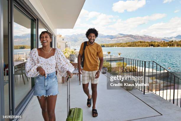 young couple walking on deck by sea in summer - travel stock-fotos und bilder
