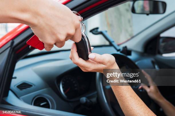 salesman handling keys to customer - försäljning av begagnad bil bildbanksfoton och bilder