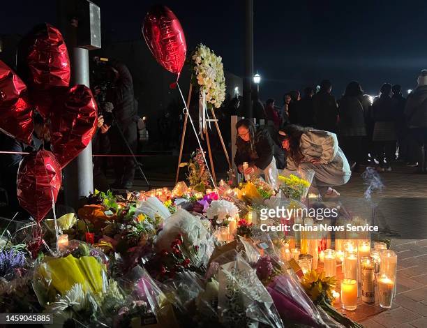 People attend a candlelight vigil for victims of a mass shooting in front of the City Hall on January 23, 2023 in Monterey Park, California. At least...
