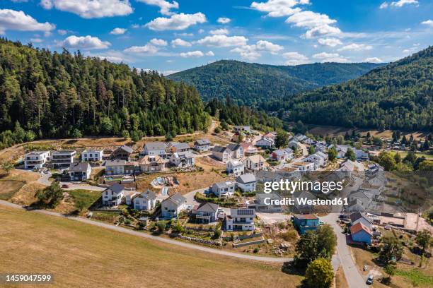 germany, baden-wurttemberg, bad herrenalb, aerial view of new modern development area with forested hills in background - black forest germany stock pictures, royalty-free photos & images