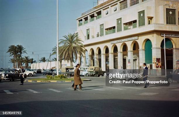 Pedestrians cross a road leading to Essaria Square, later Martyrs' Square, in the centre of Tripoli, capital city of Libya circa 1970.