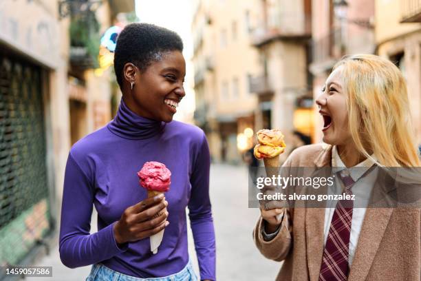 multiethnic tourists having fun while eating an ice cream outdoors - elegance is an attitude ストックフォトと画像