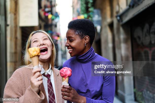 multiethnic friends having fun while eating an ice cream outdoors - beautiful people ストックフォトと画像