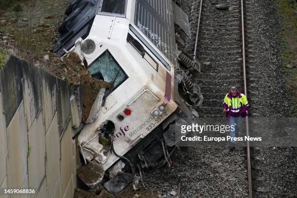 Man carries out the removal of the crashed train, on 24 January, 2023 in A Xesta, Lalin, Pontevedra, Spain. A non-hazardous goods train derailed...
