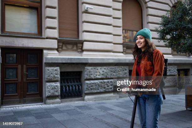 caucasian girl on her scooter - girl riding scooter stockfoto's en -beelden