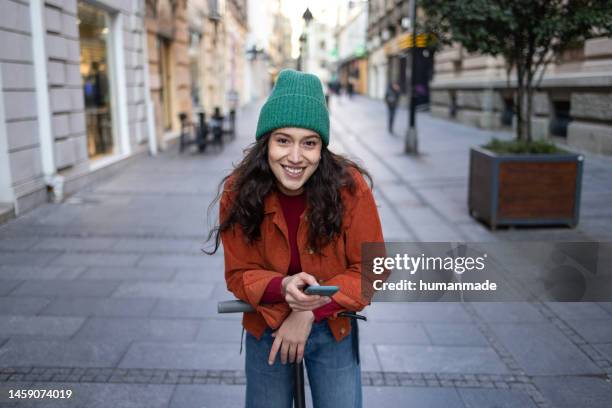 posing on electric scooter - automotive trend stock pictures, royalty-free photos & images