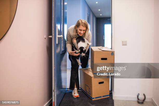 beautiful middle aged single woman moving house - house rental bildbanksfoton och bilder