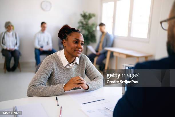 businesswoman of black ethnicity having an job interview with male recruiter - application form stock pictures, royalty-free photos & images