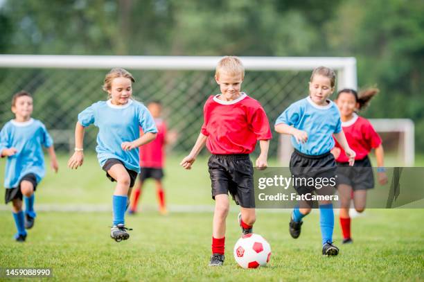 summer soccer - boy playing soccer stock pictures, royalty-free photos & images