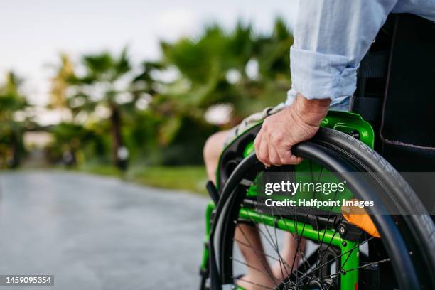 close-up of man on wheelchair. - disability rights stock pictures, royalty-free photos & images