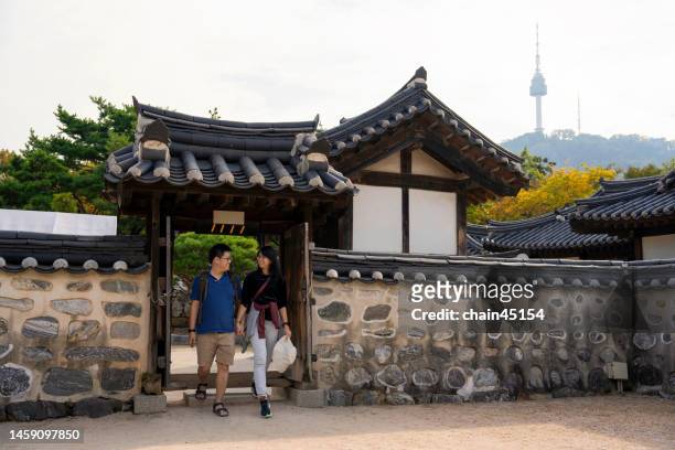 couple lover tourist travel at namsan culture hanok village to relaxation hold hands and walk together in romantic scene seoul. south korea. physical affection southeast asia concept. - seoul travel stock pictures, royalty-free photos & images