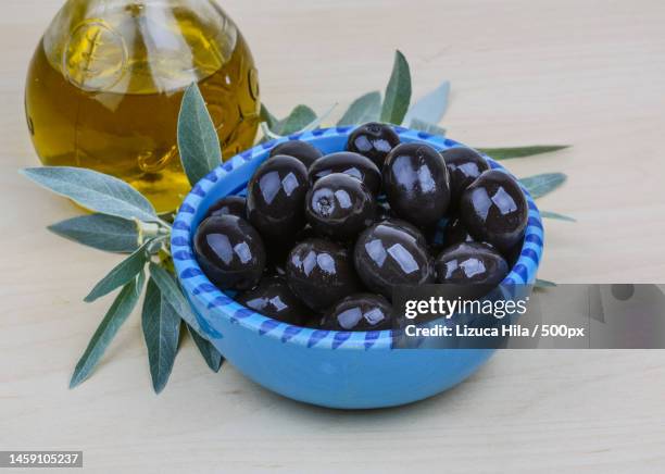 high angle view of blueberries in bowl on table,romania - black olive stock pictures, royalty-free photos & images