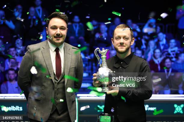 Mark Allen of Northern Ireland poses with the World Grand Prix trophy after winning the final match against Judd Trump of England on day seven of the...