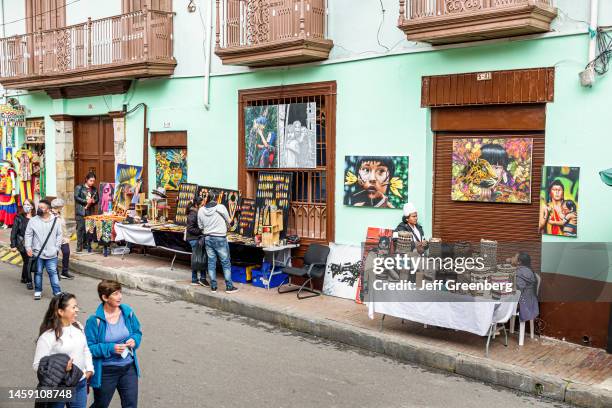 Bogota, Colombia, La Candelaria, Centro Historico, street vendors and pedestrians on street with typical colonial houses and balconies.