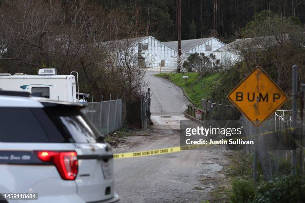 San Mateo County sheriff deputy blocks the entrance to a farm following a mass shooting on January 24, 2023 in Half Moon Bay, California. Seven...