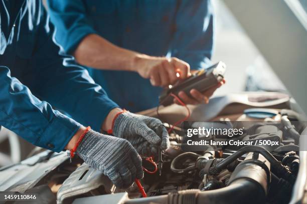 midsection of mechanic repairing car engine,romania - car repair stock pictures, royalty-free photos & images