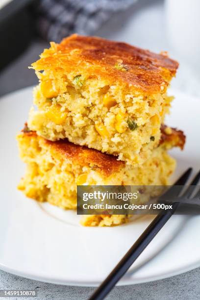 portion of christmas cheddar cornbread on white plate festive recipe food concept,romania - cornbread stock pictures, royalty-free photos & images