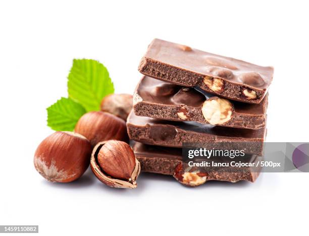 chocolate with hazelnuts nuts on white backgrounds,romania - close up of chocolates for sale stock pictures, royalty-free photos & images