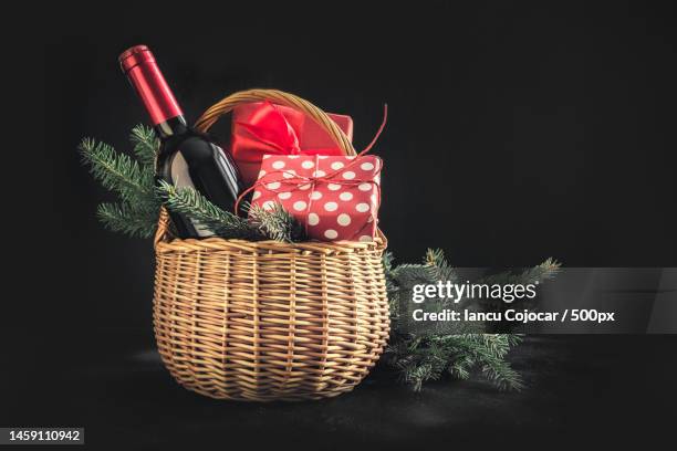 christmas gift hamper with red wine and gift on black space for your greetings xmas card,romania - gift hamper stock pictures, royalty-free photos & images