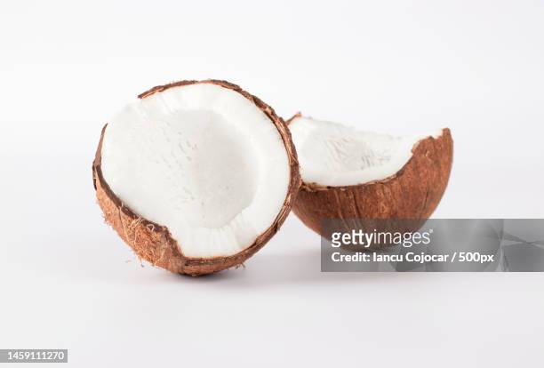 two halves of fresh coconut on white background close-up,romania - coconut imagens e fotografias de stock