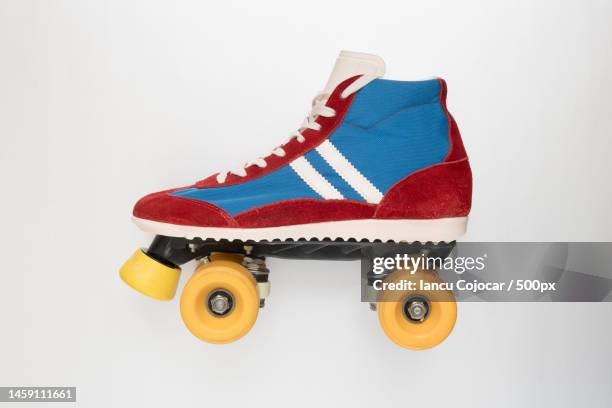 side view of a roller skate with yellow wheels,romania - rolschaatsen schaats stockfoto's en -beelden