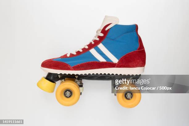 side view of a roller skate with yellow wheels,romania - single object plain background stock pictures, royalty-free photos & images