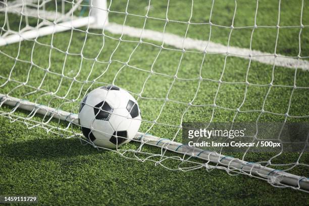 close-up of soccer ball on field,romania - net sports equipment stock-fotos und bilder